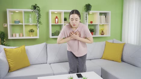 Asian-young-woman-experiencing-chest-pain-or-tightness.